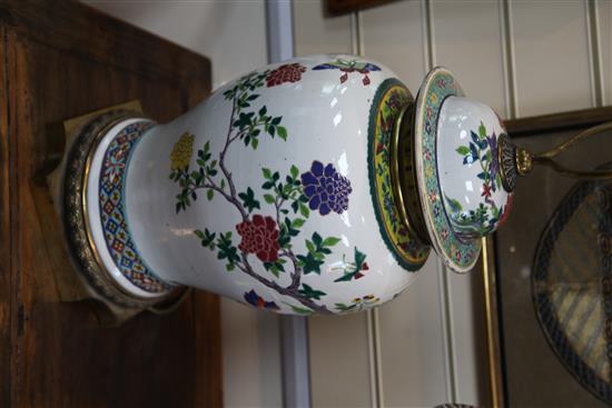 A pair of large Chinese famille rose baluster jars and covers, late 19th / early 20th century, 80.5cm to top of brass fittings